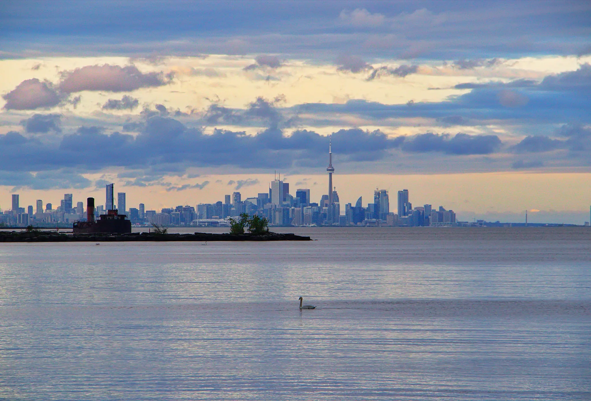 The Toronto skyline seen across Lake Ontario under an overcast sky